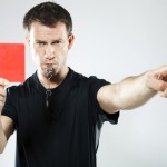 Soccer referee showing a red card and blowing a whistle